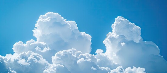 Poster - Soft-focus white clouds against a blue sky form a serene backdrop with a horizontal copy space image.