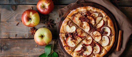 Poster - Apple, cinnamon, and chocolate pizza dessert on a wooden backdrop, displayed from above with available copy space for an image.