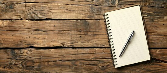 Aufkleber - Wooden table with a notebook and ball pen, providing ample copy space image.