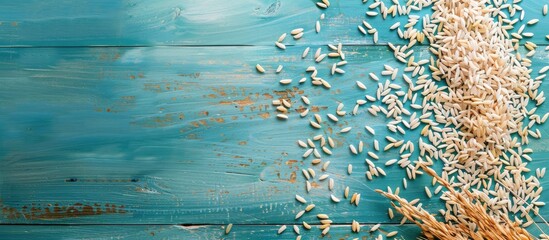 Poster - Top-down perspective of dried paddy rice on a blue wooden surface, offering room for text or design in a copy space image.