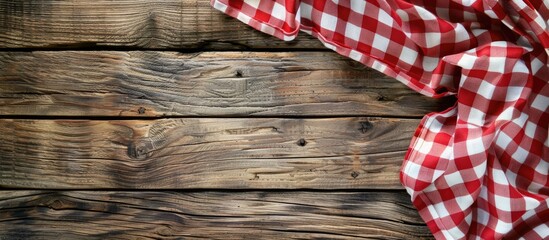 Aufkleber - Checkered red and white tablecloth displayed on wooden background with copy space image.