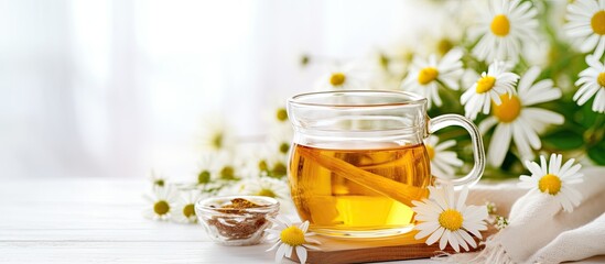 Canvas Print - Chamomile tea with flowers, honey, and lemon on a white table, surrounded by a chamomile bouquet. Reflects the concept of relaxing herbal drinks and natural healing. Immunity-boosting tea. Close-up