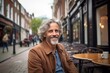 © Stocknterias - Portrait of a handsome senior man with grey hair in an outdoor cafe