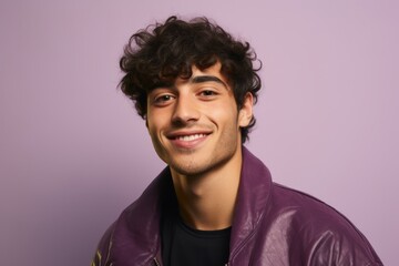 Poster - Portrait of a smiling young man in leather jacket on purple background