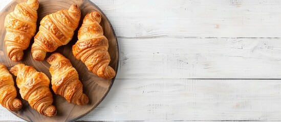 Aufkleber - Top view of croissants presented on a white wooden board with ample copy space image