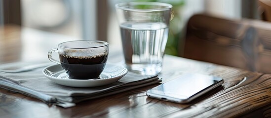 Poster - Coffee concept A serene scene with black coffee a glass of water and a mobile phone resting on a table inviting relaxation ideal for copy space images