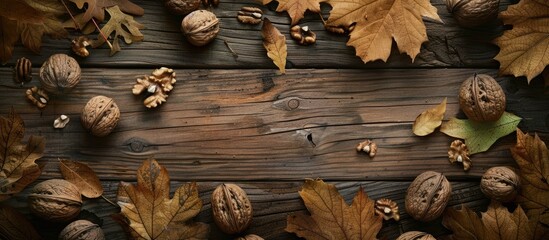 Aufkleber - Vintage wooden table adorned with walnuts and leaves creating a rustic setting with copy space image
