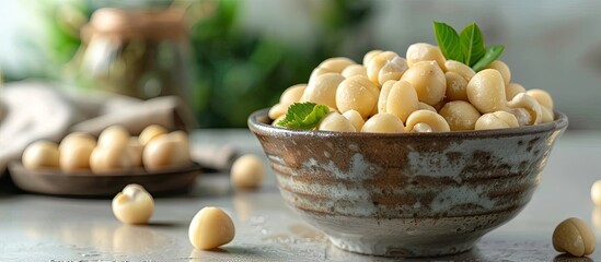 Aufkleber - Peeled Macadamia nuts displayed in a bowl on a bright table with copy space image available