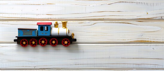 Poster - Toy train on white wooden background with copy space image for text seen from top down layout