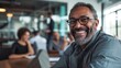 © AlfaSmart - A businessman smiles confidently during a meeting in a modern office