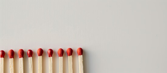 Poster - A row of matches on a white surface with copy space image available