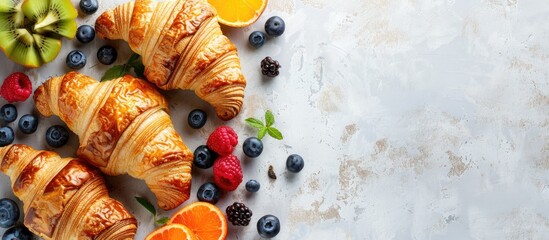 Fototapete - Croissants with assorted fruits placed elegantly on a bright backdrop perfect for a copy space image