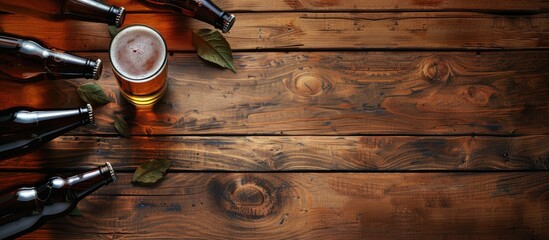 Aufkleber - Top view of a beer glass on a wooden table with beer bottles around it The image features selective focus and a blank template for copy space