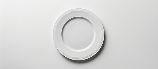 Poster - Top view of an unblemished plate on a white backdrop with copy space image