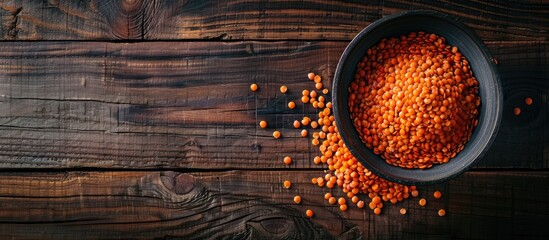Aufkleber - Red lentil bowl arranged on a wooden surface with copy space image