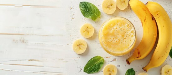 Aufkleber - Banana smoothie refreshingly laid on a white wooden surface with copy space image