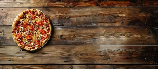 Poster - Scrumptious pizza on a wooden table with copy space image