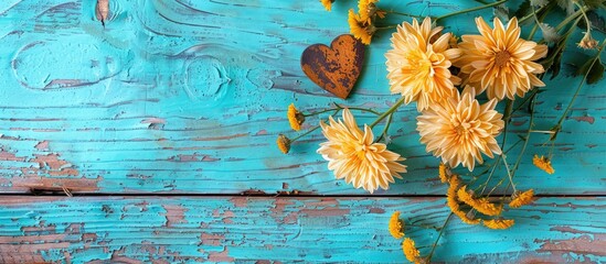 Poster - Top view of chrysanthemums and heart placed on a weathered turquoise wooden surface with space for additional images