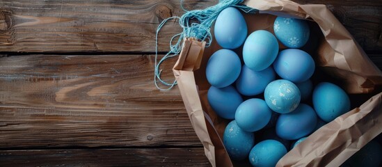 Poster - Gift bag and blue Easter eggs viewed from above with room for text or graphics in the image. with copy space image. Place for adding text or design