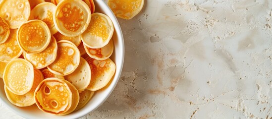 Aufkleber - Top view background of mini pancakes a menu concept for sweet breakfast or dessert with space for text showcasing a healthy organic snack serving size. with copy space image