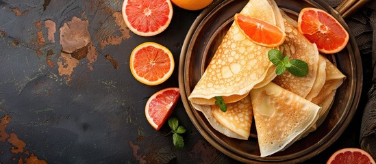 Fototapete - Rustic top view of tasty fresh grapefruit crepes on a table with copy space image ideal for a healthy meal or snack