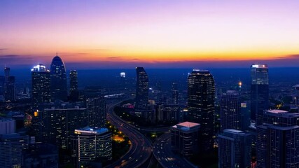 Aufkleber - A panoramic view of modern city at sunset, showing the city's modern skyscrapers and cityscape illuminated by the setting sun.