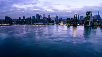 Poster - A panoramic view of a city skyline at dusk, featuring numerous skyscrapers reflected in the calm water.