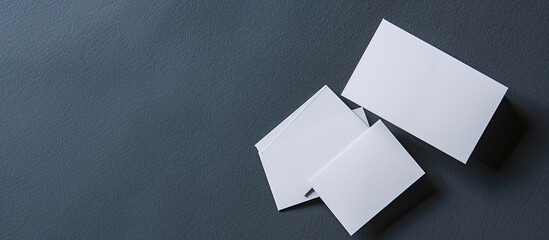 Poster - Top view of blank business cards on a dark grey backdrop perfect for adding designs with a copy space image