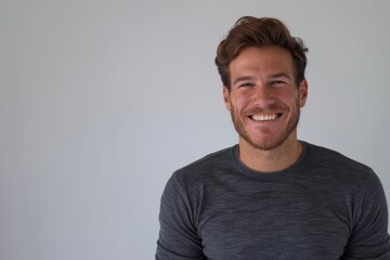 Sticker - Portrait of a happy caucasian man in his 20s showing off a thermal merino wool top isolated in plain white digital canvas