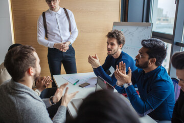 Canvas Print - Caucasian team building male coach answering questions that multiethnic audience ask during business seminar, close up