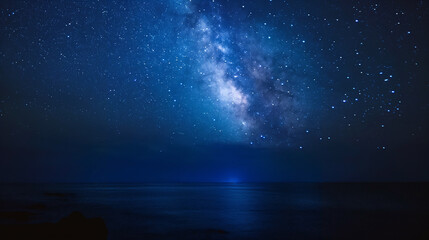 Wall Mural - the night sky is filled with stars and the ocean is calm