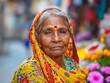 © AI_Imaginator - Portrait of an elderly Indian woman wearing a yellow sari and a red bindi.
