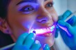 © Valentin - Dental Professional Performing Teeth Whitening Procedure with UV Light