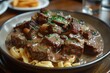 A plate of beef stroganoff with tender beef strips in a creamy mushroom sauce, served over a bed of egg noodles. 