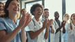© VK Studio - A diverse group of healthcare professionals applauds in a well-lit room, filled with positivity and teamwork.