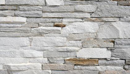 Stone wall texture background - grey stone siding with different sized stones