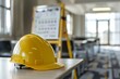 © Valentin - Safety Training Session in Progress with Yellow Hard Hat on Table