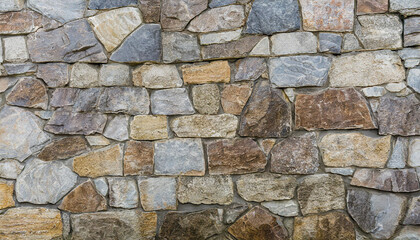 Stone work. Masonry made of old stone. Set of stones of different shapes and colors.