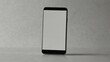 © Андрій Гатченко - Minimalist smartphone with blank screen standing upright on light gray surface