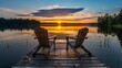 © Sasa Visual - Two Adirondack chairs sit on a wooden dock facing a sunset over a calm lake