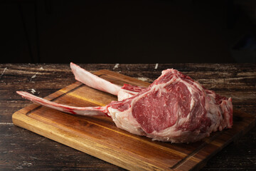 Wall Mural - fresh tomahawk beef steak on cutting board