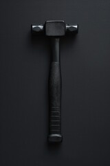Poster - A close-up shot of a hammer lying on a black surface, with a black background
