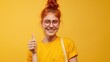 © hanafi 99d - A girl with red hair and glasses is giving a thumbs up on yellow background