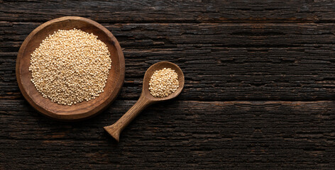 Wall Mural - Chenopodium quinoa - White organic quinoa seeds in the bowl and spoon - Rustic background