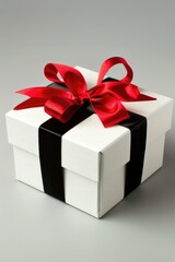 Poster - A beautifully wrapped gift box tied with a red ribbon, suitable for special occasions and celebrations