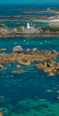 Wall Mural - Aerial view of Pontusval Lighthouse and the beaches. Plounéour-Brignogan-Plages, France. Rocks singularly shaped. Boats moored in the Atlantic Ocean. The Coast of Legends