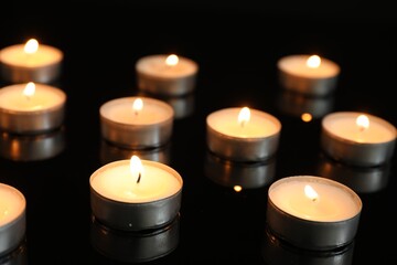 Sticker - Many burning tealight candles on mirror surface against black background