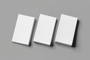 Poster - Three white books stacked on a surface, possibly in a home or office setting