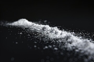 Wall Mural - A pile of white sugar on a dark background