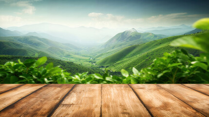 Poster - Empty wooden table displaying beautiful green mountain landscape with a river flowing through the valley